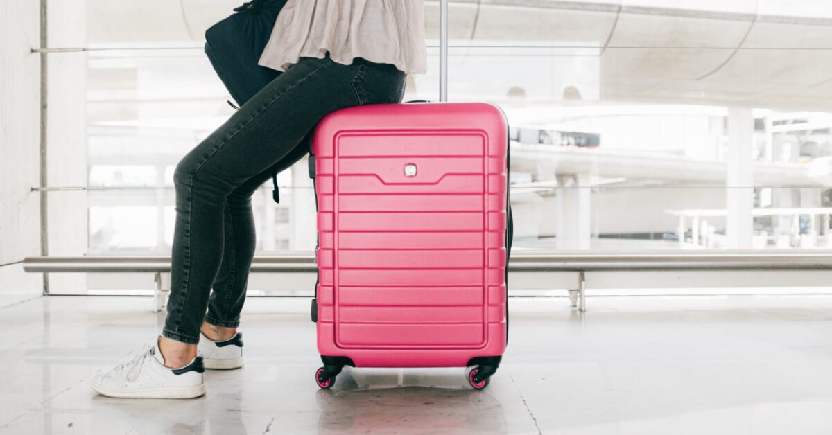 pink-suitcase-woman-travel-white-airport-clean
